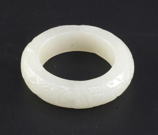 A Chinese white jade bangle or ring, diameter 5.7cm